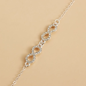Detailed macro view of silver infinity chain with sparkling zircon stones inlay