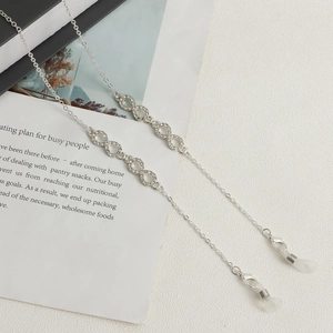 Detail of silver infinity symbol glasses chain with rhinestones and anti-slip rings