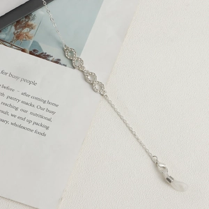 Detail of silver glasses chain with rhinestone infinity charms and lobster clasp