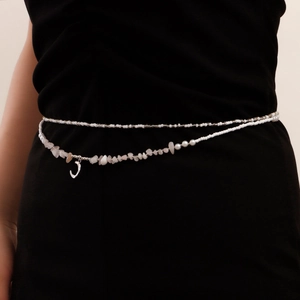 Detail of double-layer bohemian waist chain with white beads, stones and moon pendant