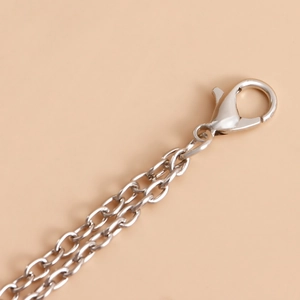 Detail view of silver metal chain with a secure lobster clasp and polished finish