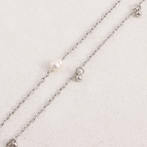 Detail view of double layer metal body chain with silver beads and white pearls