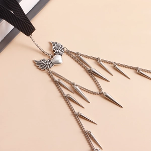 Detailed macro view of silver winged heart leg chain featuring multiple dangling metal spikes