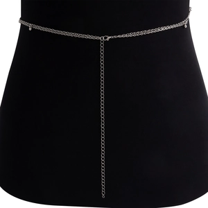 Detail of silver layered waist chain with metal beads and lobster clasp on black mannequin