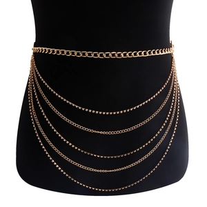 Detailed view of layered gold body chain with shimmering rhinestones on black model