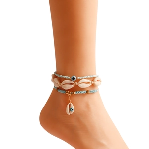 Detail view of Bohemian three-layer anklet with natural shells and blue evil eye beads