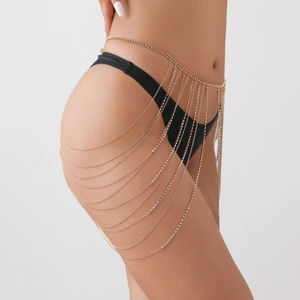Detail of a layered gold body chain featuring sparkling rhinestones on an elegant waist belt