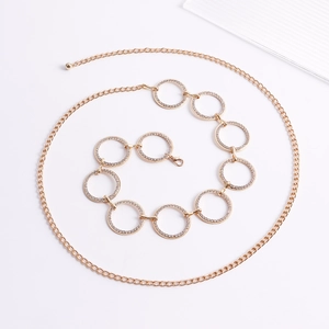 Dettaglio della catena dorata da vita con nove anelli decorati con strass lucidi e scintillanti