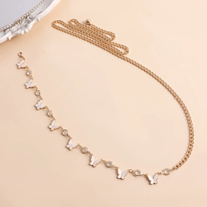 Detail of gold metal waist chain with white butterfly pendants and rhinestones