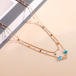 Detail of double-layer gold chain body belt with colorful butterfly and crystal accents