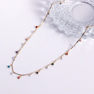 Detailed macro view of the double-layered golden chain body belt with colorful oil drop beads