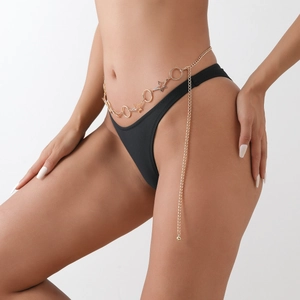 Detail of a golden starfish belly chain featuring sparkling star and ring charms for women
