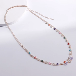 Detail of double-layer waist chain with colorful heart charms and purple butterfly pendants