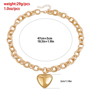 Golden chunky chain necklace with a large heart pendant and adjustable length chain