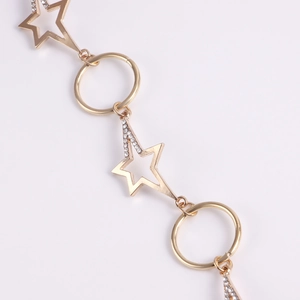 Close-up of golden starfish and ring chain links with sparkling crystal accents