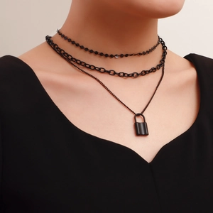 Three-layer matte black chain necklace featuring a minimalist padlock pendant on model