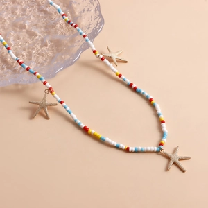 Detail showing colorful seed beads and golden starfish pendants on a summer body chain