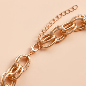 Detail of chunky gold chain necklace with lobster clasp and adjustable extension links
