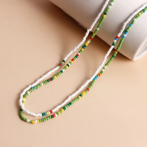 Detail of colorful seed bead necklaces with shell and starfish on a pedestal