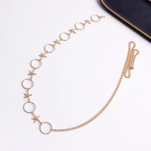 Detailed close-up of golden starfish and circular metal rings on a stylish waist chain
