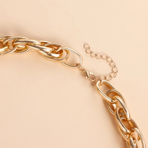 Close-up of golden chunky link necklace with secure lobster clasp and adjustable chain