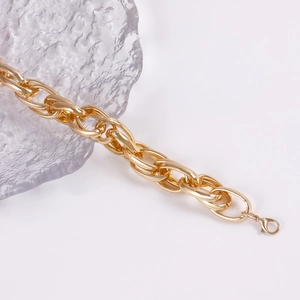 Detail shot of chunky gold link necklace with mirror finish and lobster clasp closure