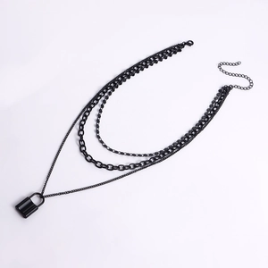 Close-up of multi-layer black chain necklace with a padlock pendant and lobster clasp