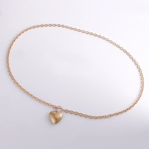 Detail of gold-tone aluminum chain with large heart pendant and toggle clasp closure