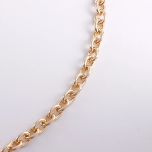 Close-up of polished gold-tone aluminum chain links with reflective mirror surface
