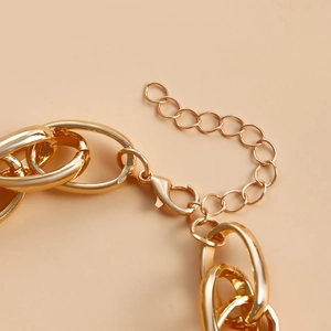 Detailed close-up of gold chunky chain lobster clasp and adjustable extension link