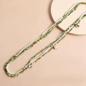 Detail of bohemian waist chain with colorful beads and golden butterfly pendants