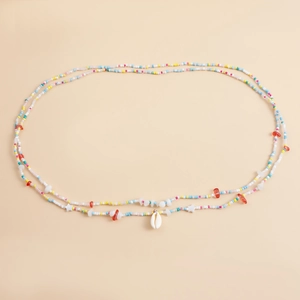 Detail of colorful beaded waist chain with star beads and natural seashell pendant