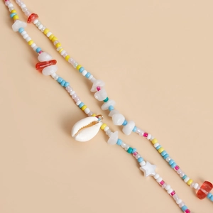 Detail of bohemian waist chain featuring colorful beads, shells, and starfish charms