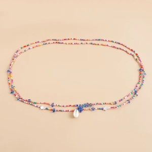Detail of colorful beaded waist chain with a natural shell pendant and starfish beads