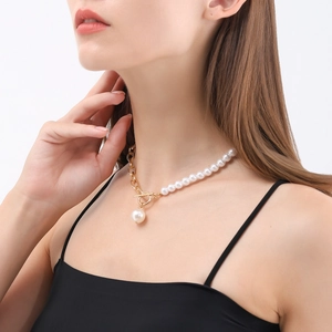 Detail of gold chain and pearl necklace featuring OT toggle clasp and pearl pendant