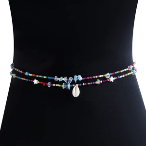 Detail of bohemian waist chain with colorful beads, blue stones and white shell pendant