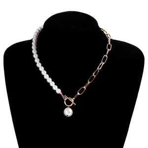 Close-up of pearl necklace with gold rectangle links, OT buckle and teardrop pendant