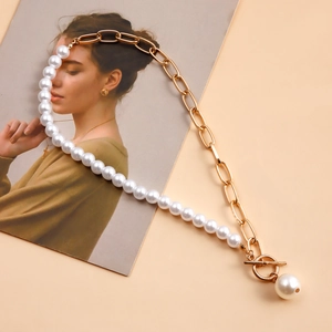 Detail of mixed-media necklace with gold chain, white pearls and OT toggle clasp