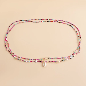 Detail of colorful beads body chain featuring a white seashell and starfish charms