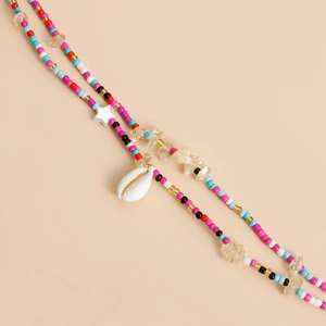 Detailed shot of bohemian waist chain featuring colorful beads, shells, and starfish charm
