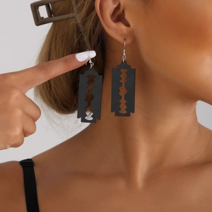 Fashionable black acrylic razor blade drop earrings on a model for a creative look