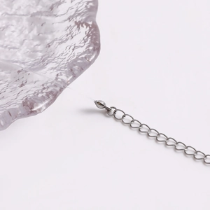 Detail shot showing the transparent crystal line and silver-tone metal extension chain.