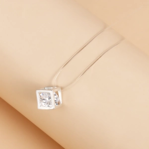 Macro shot of cubic zircon pendant on invisible thread with silver frame details