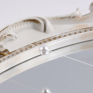 Macro detail of a white pearl bead with elegant luster on a clear fishing line string