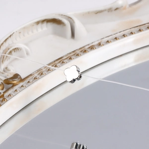 Macro view of polished silver clover pendant with smooth surface on clear cord