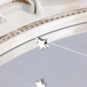 Macro shot of polished silver star pendant with hole for jewelry making
