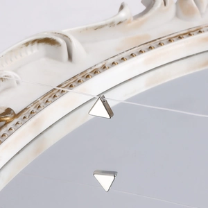 Close-up of minimalist silver triangle pendant on transparent thread with mirror reflection