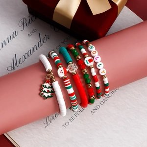 Detail of five-piece Christmas elastic bracelet set featuring Santa and Holly beads