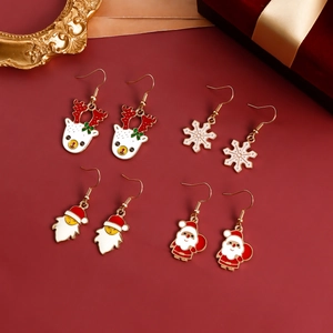 Four pairs of festive Christmas earrings with Santa Claus and Reindeer on a red background