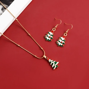 Close-up of golden Christmas tree necklace and earrings set with enamel details